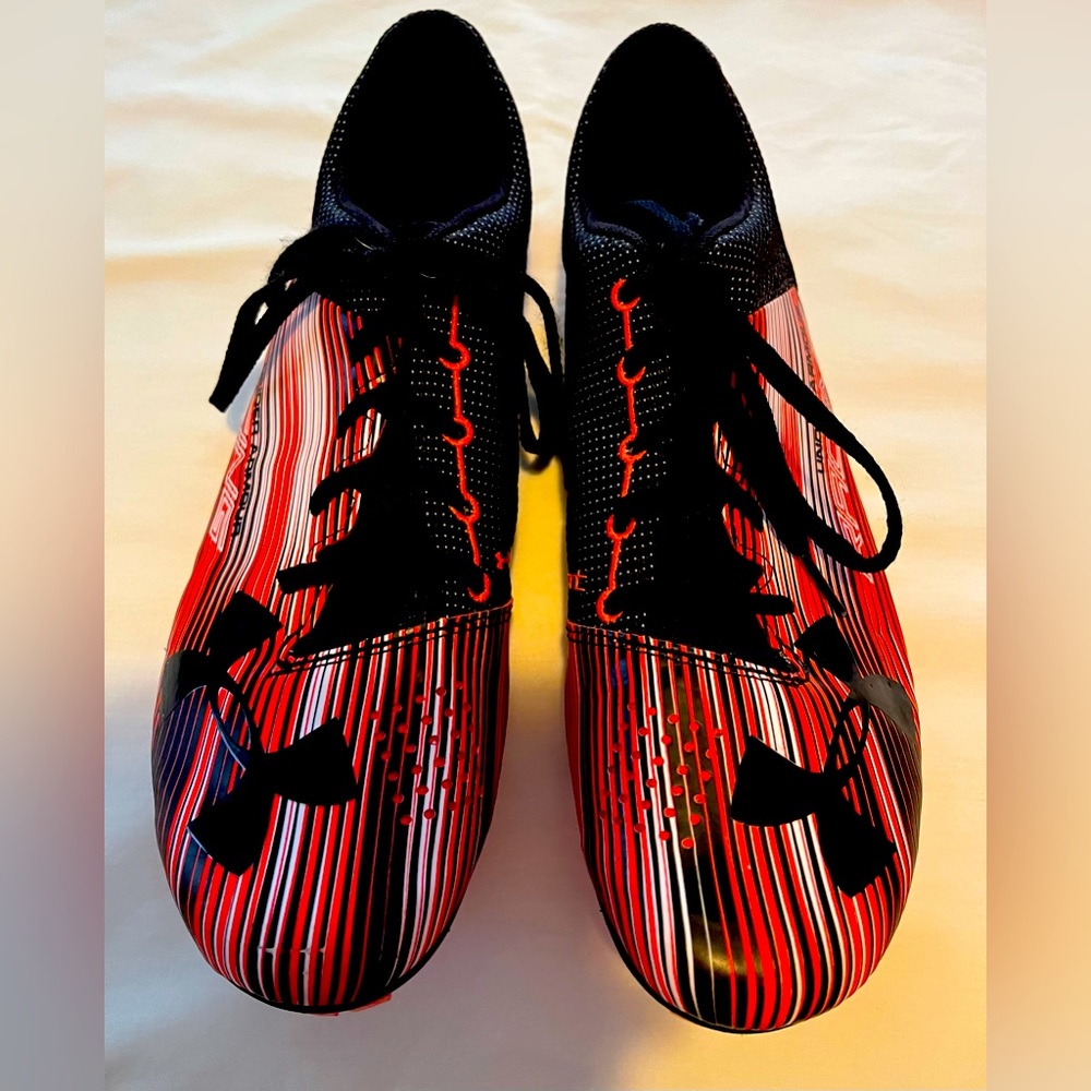 Under Armour racing sprinter spikes.  Included neon Nike bag.
